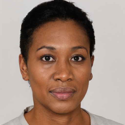 Joyful black young-adult female with short  black hair and brown eyes