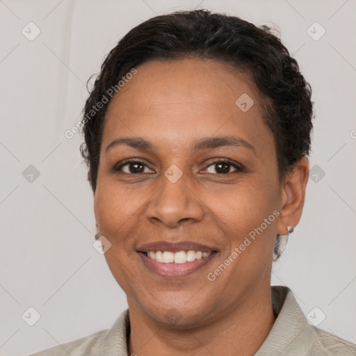 Joyful black adult female with short  brown hair and brown eyes