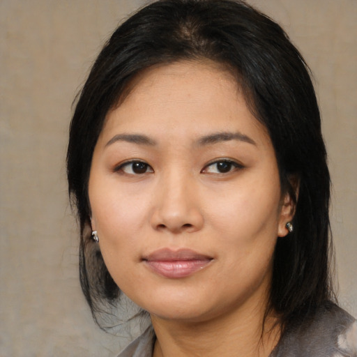 Joyful asian young-adult female with medium  black hair and brown eyes