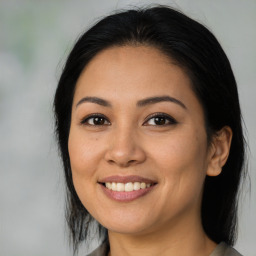 Joyful latino young-adult female with medium  black hair and brown eyes