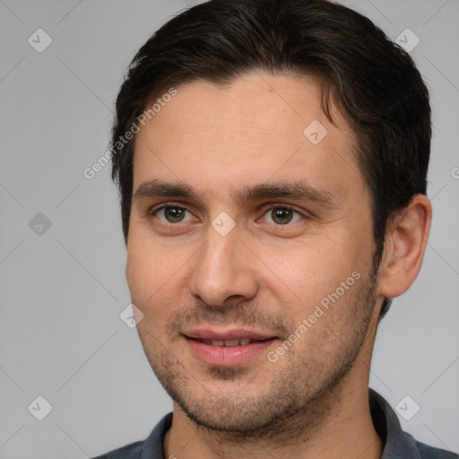 Joyful white young-adult male with short  brown hair and brown eyes