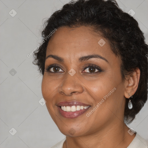 Joyful black adult female with medium  brown hair and brown eyes