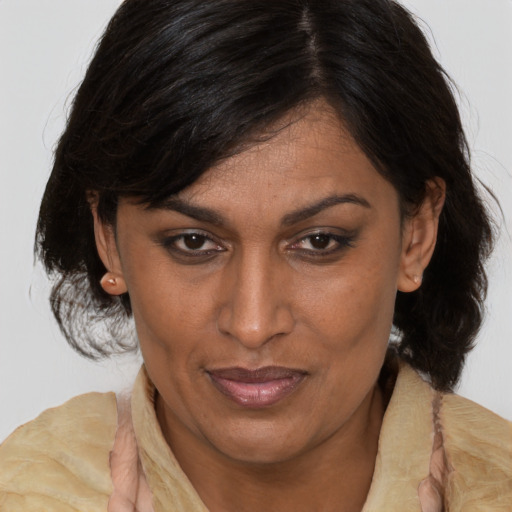 Joyful asian adult female with medium  brown hair and brown eyes
