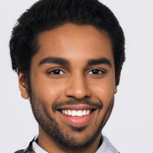 Joyful black young-adult male with short  black hair and brown eyes