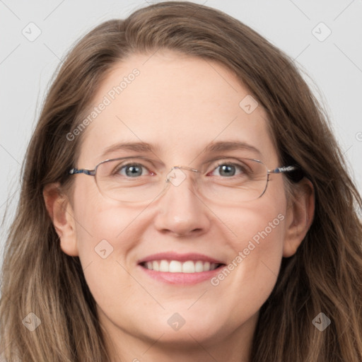 Joyful white adult female with long  brown hair and grey eyes