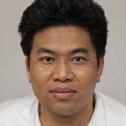 Joyful asian adult male with short  black hair and brown eyes