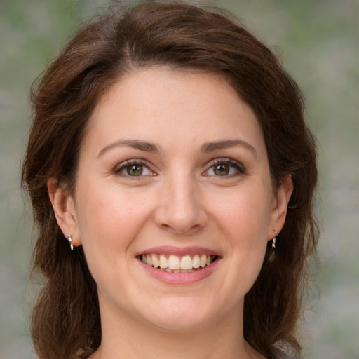 Joyful white young-adult female with medium  brown hair and green eyes