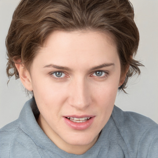 Joyful white young-adult female with short  brown hair and blue eyes