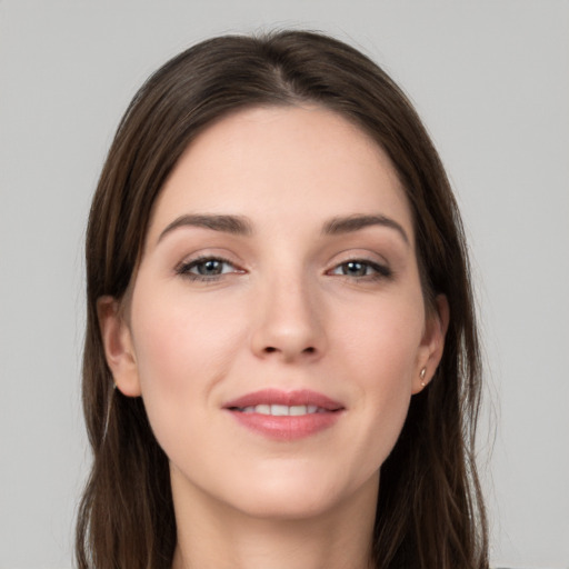 Joyful white young-adult female with long  brown hair and grey eyes