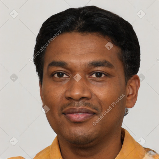 Joyful latino young-adult male with short  black hair and brown eyes