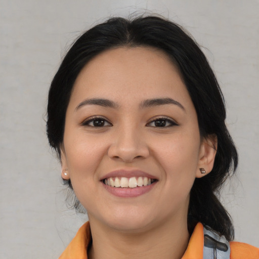 Joyful latino young-adult female with medium  black hair and brown eyes