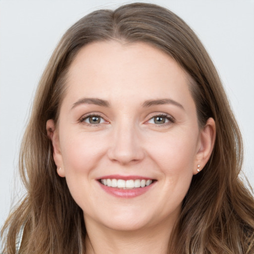 Joyful white young-adult female with long  brown hair and grey eyes