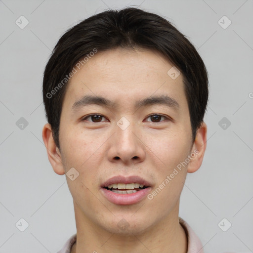 Joyful asian young-adult male with short  brown hair and brown eyes