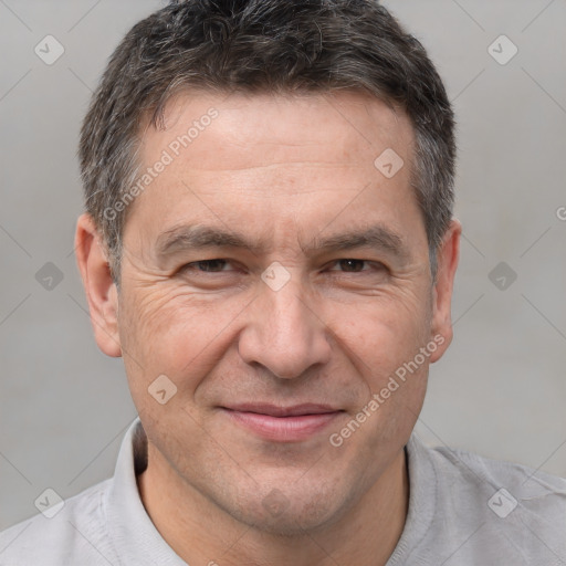 Joyful white adult male with short  brown hair and brown eyes