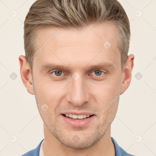 Joyful white young-adult male with short  brown hair and grey eyes