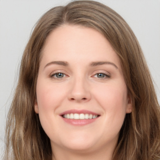 Joyful white young-adult female with long  brown hair and grey eyes