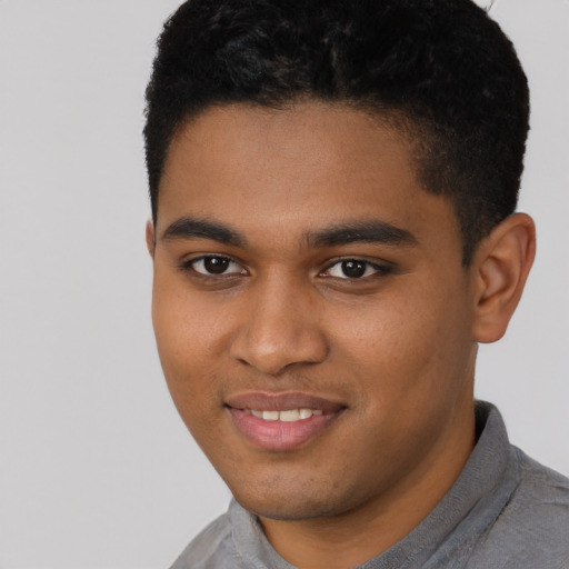 Joyful black young-adult male with short  black hair and brown eyes