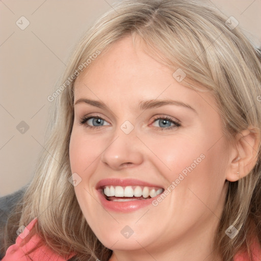 Joyful white young-adult female with medium  brown hair and blue eyes