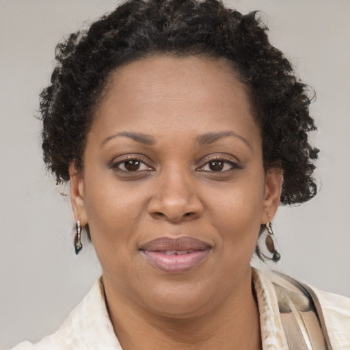 Joyful black adult female with short  brown hair and brown eyes