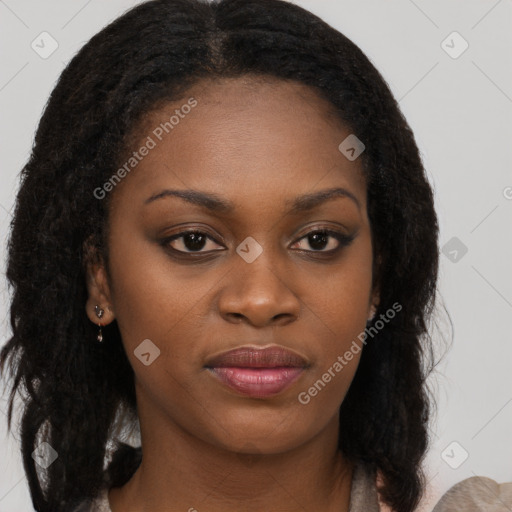 Joyful black young-adult female with long  brown hair and brown eyes