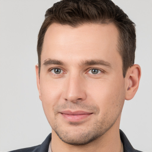 Joyful white young-adult male with short  brown hair and brown eyes