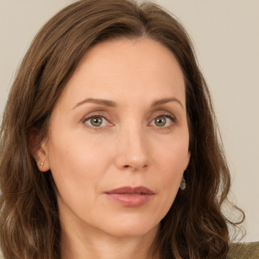 Joyful white young-adult female with long  brown hair and green eyes