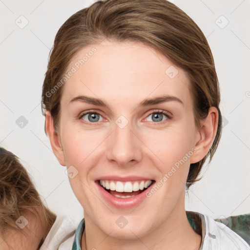 Joyful white young-adult female with medium  brown hair and blue eyes