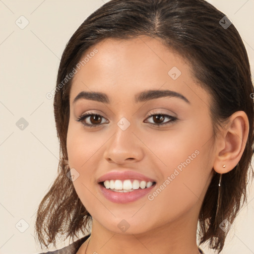 Joyful white young-adult female with long  brown hair and brown eyes