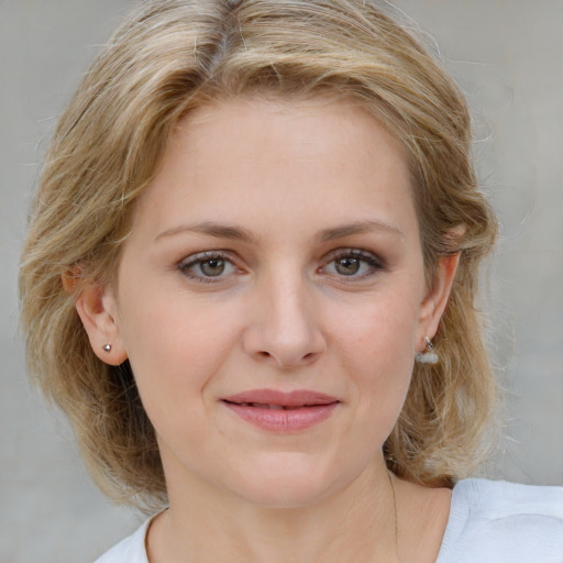 Joyful white young-adult female with medium  brown hair and blue eyes