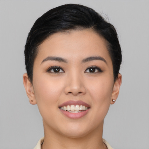 Joyful asian young-adult female with short  brown hair and brown eyes