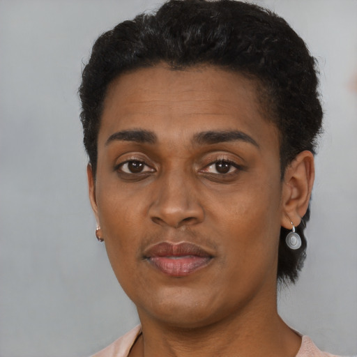 Joyful black young-adult female with short  brown hair and brown eyes