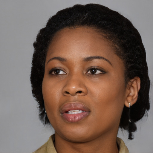 Joyful black young-adult female with medium  black hair and brown eyes