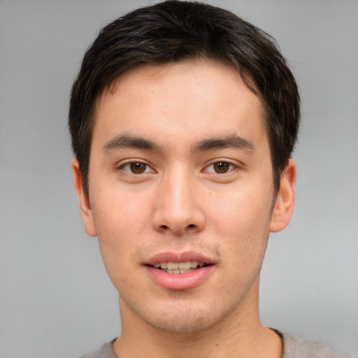 Joyful asian young-adult male with short  brown hair and brown eyes