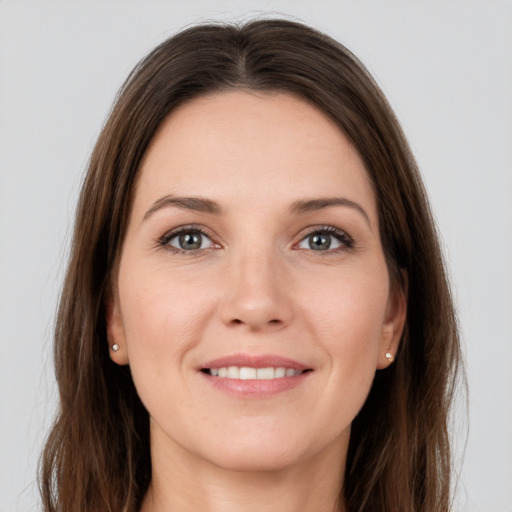 Joyful white young-adult female with long  brown hair and grey eyes