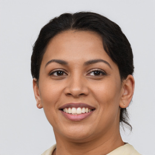 Joyful latino young-adult female with short  brown hair and brown eyes