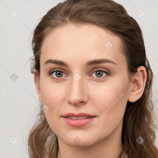 Joyful white young-adult female with long  brown hair and grey eyes