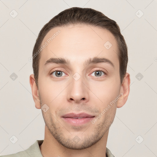 Joyful white young-adult male with short  brown hair and grey eyes