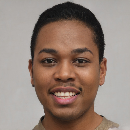 Joyful black young-adult male with short  black hair and brown eyes