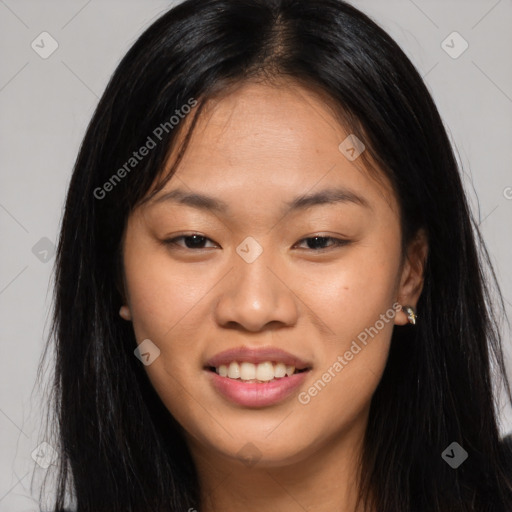 Joyful asian young-adult female with long  brown hair and brown eyes