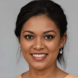 Joyful latino young-adult female with medium  brown hair and brown eyes