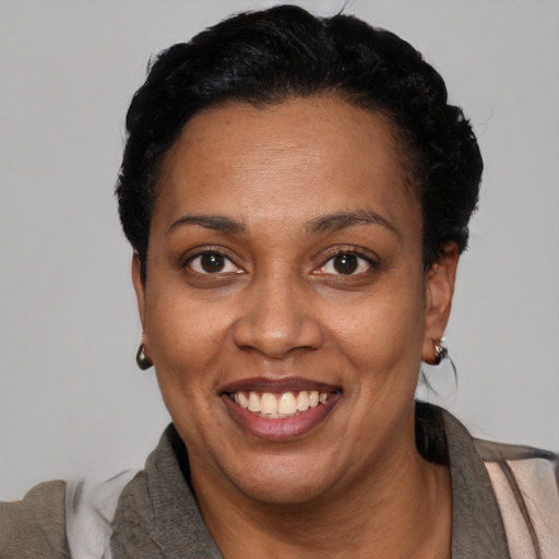 Joyful latino adult female with short  black hair and brown eyes