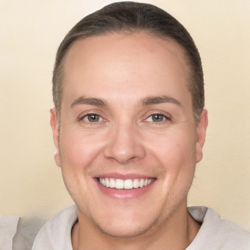 Joyful white adult male with short  brown hair and brown eyes