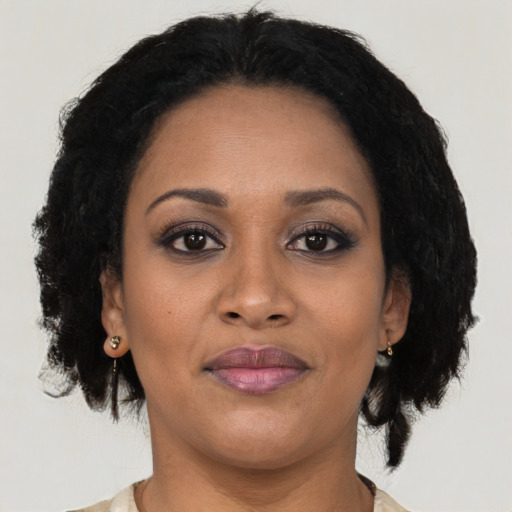 Joyful black young-adult female with medium  brown hair and brown eyes