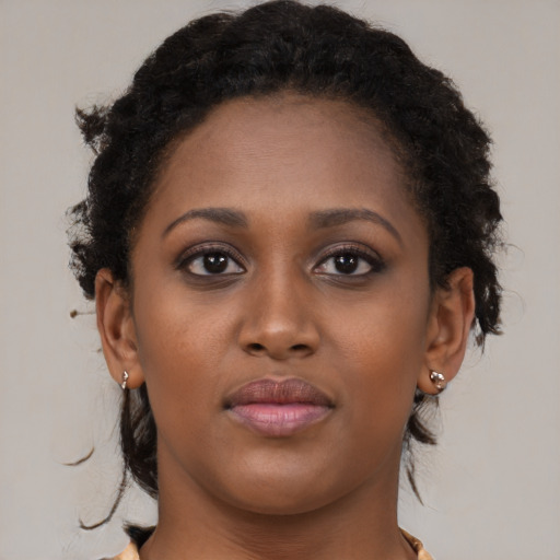 Joyful black young-adult female with medium  brown hair and brown eyes