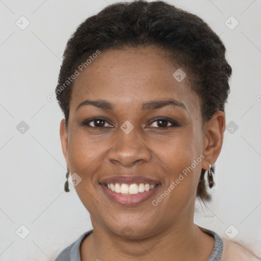 Joyful black young-adult female with short  brown hair and brown eyes