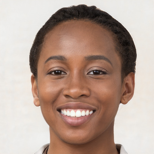 Joyful black young-adult female with short  brown hair and brown eyes