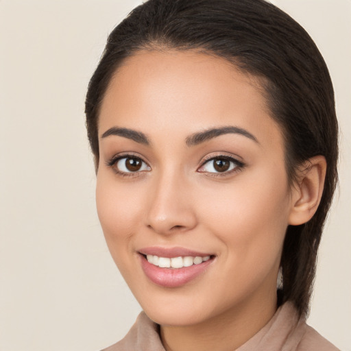 Joyful white young-adult female with long  brown hair and brown eyes