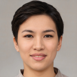 Joyful asian young-adult female with short  brown hair and brown eyes