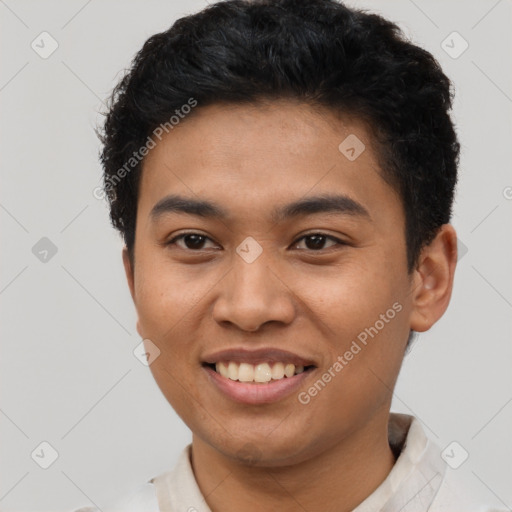 Joyful latino young-adult male with short  brown hair and brown eyes