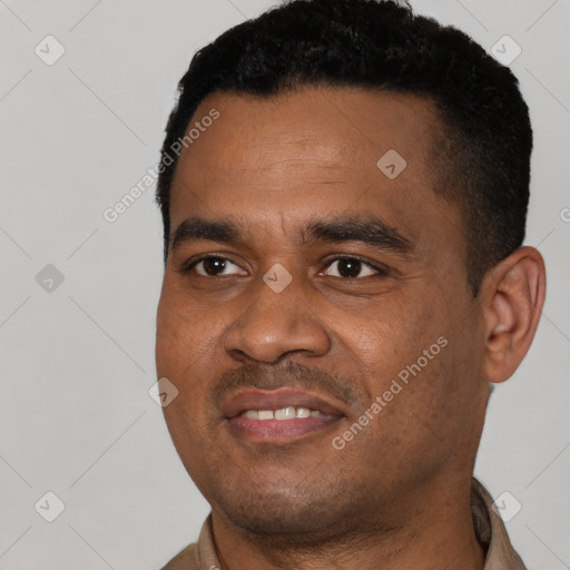 Joyful latino young-adult male with short  black hair and brown eyes